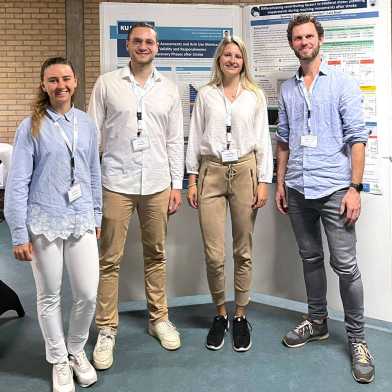 Anna, Tim, Nadine and Johannes in front of a scientific poster