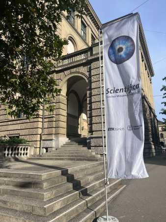 Scientifica Flag in front of aold building