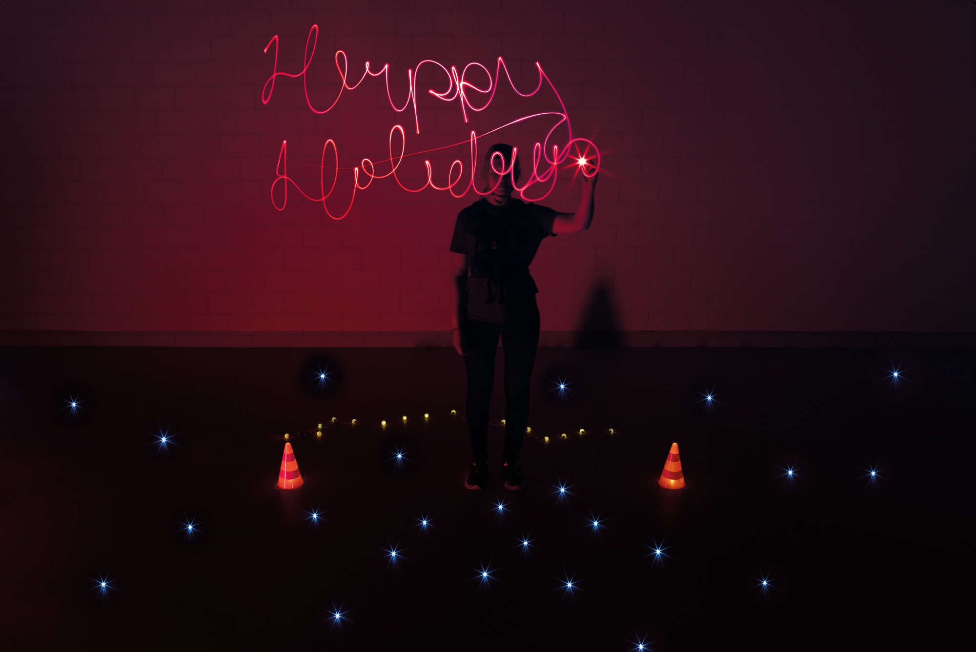 Enlarged view: Woman lightpainting the Words Happy Holliday