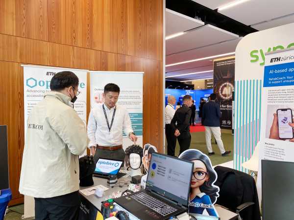 Enlarged view: Two people discussing at an exhibition stand